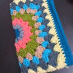 multicoloured handmade crochet purse crocheted with blue grey green rose yarns
