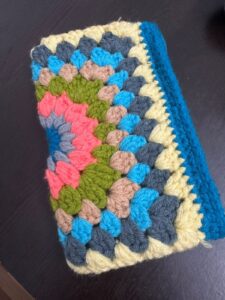 multicoloured handmade crochet purse crocheted with blue grey green rose yarns