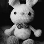 handmade unique white crochet rabbit, amigurumi with grey leg crochet black eye button and grey crochet bow on nech