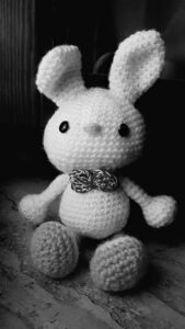 handmade unique white crochet rabbit, amigurumi with grey leg crochet black eye button and grey crochet bow on nech